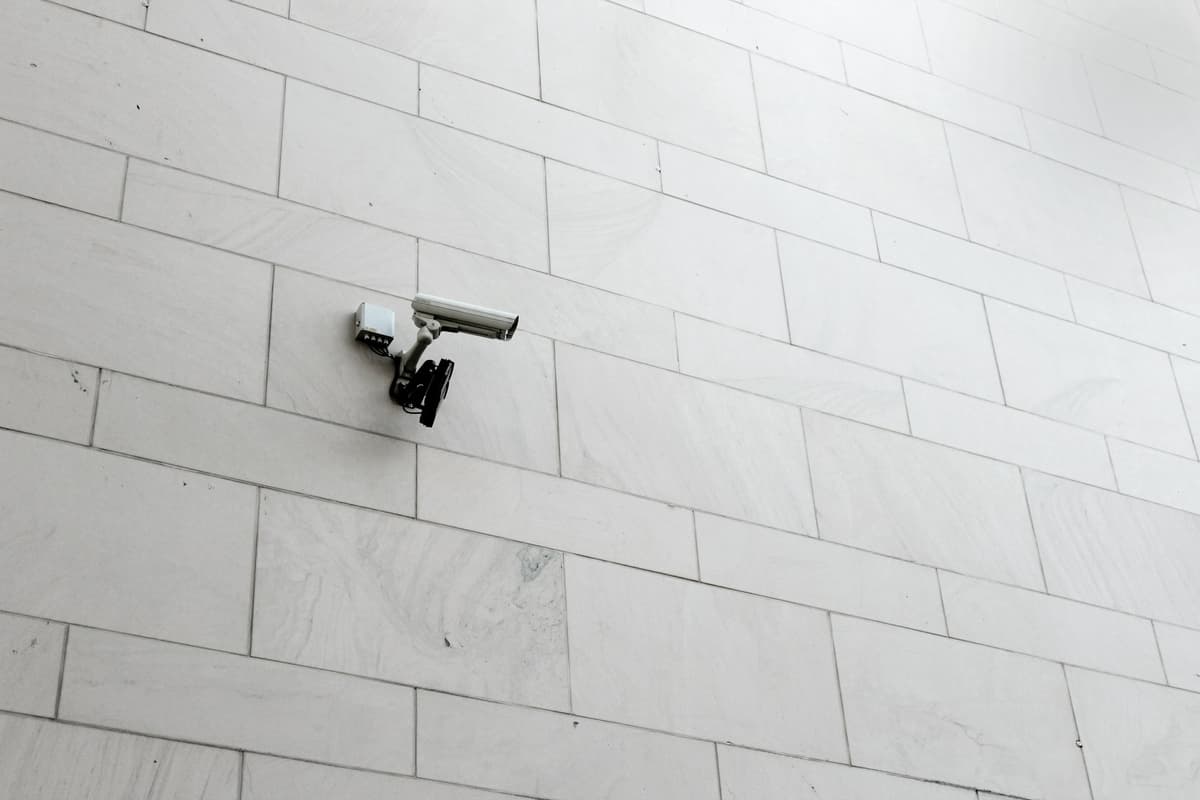 white cctv camera on a white wall
